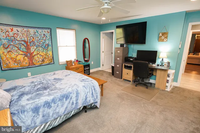 a living room with furniture a flat screen tv and a dresser
