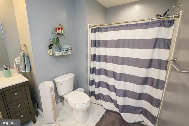 a bathroom with a double vanity sink mirror and toilet