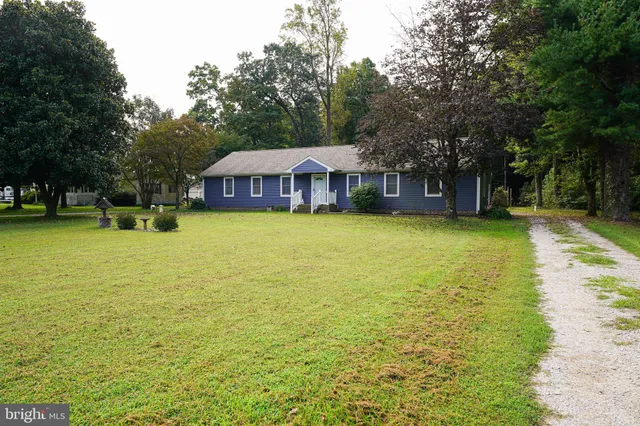 a view of a patio with a table and chairs under an umbrella
