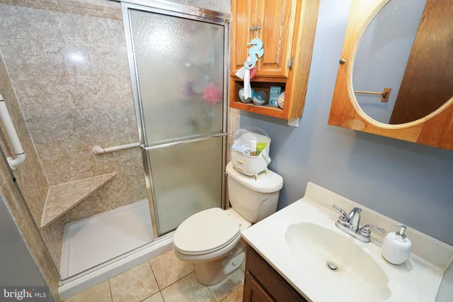 a bathroom with a sink mirror and toilet