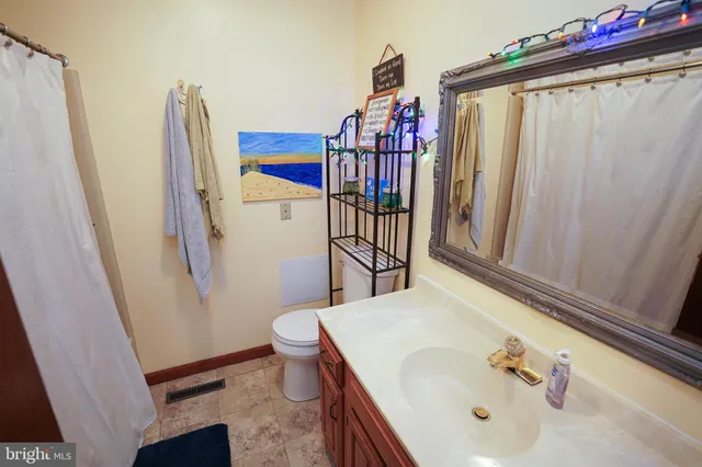 a bathroom with a sink mirror and vanity