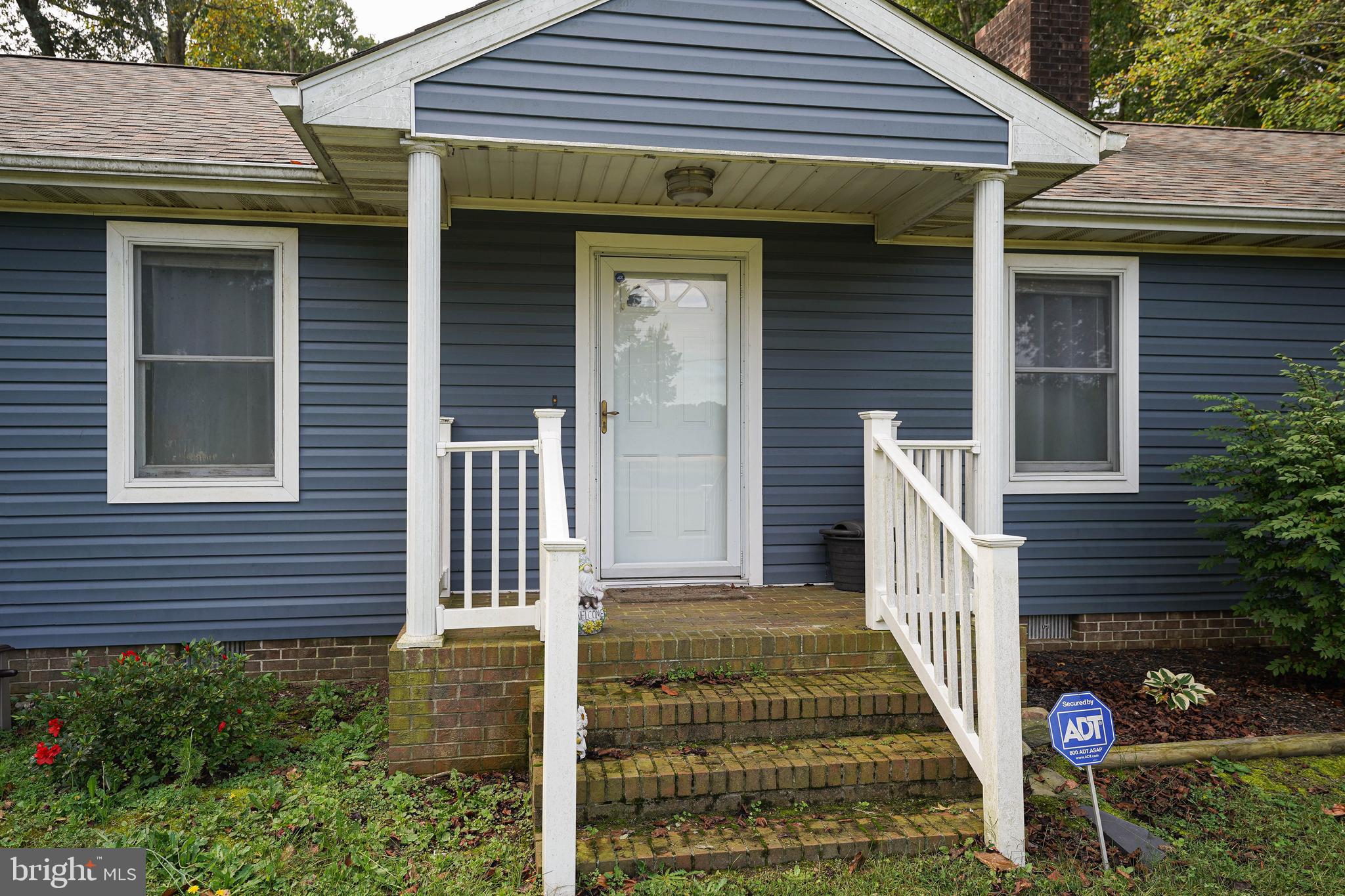 29325 West Line Road Delmar, MD 21875 - Photo 4 of 48 a front view of a house with a garden