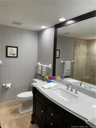a bathroom with a double vanity sink toilet and a mirror