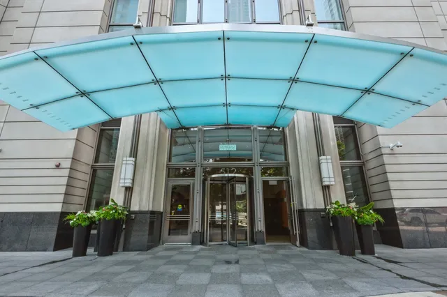 a view of a house with potted plants