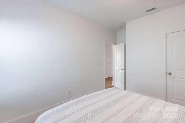 a view of a room with a white wall and a window