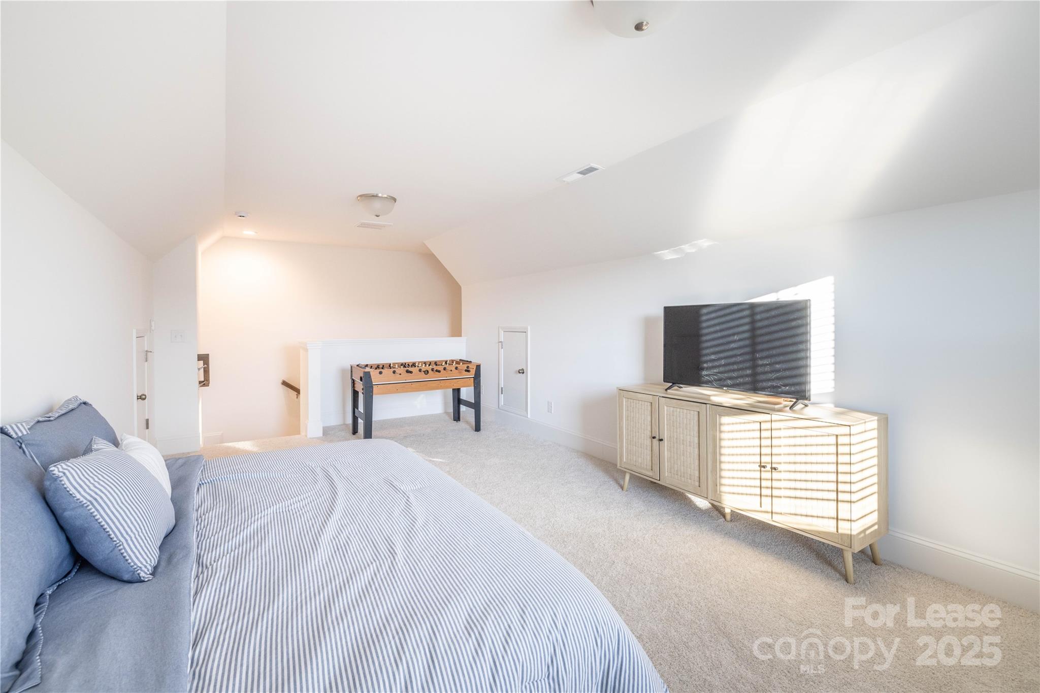 173 Tillery Lane Mount Gilead, NC 27306 - Photo 14 of 28 a bedroom with a bed and flat screen tv