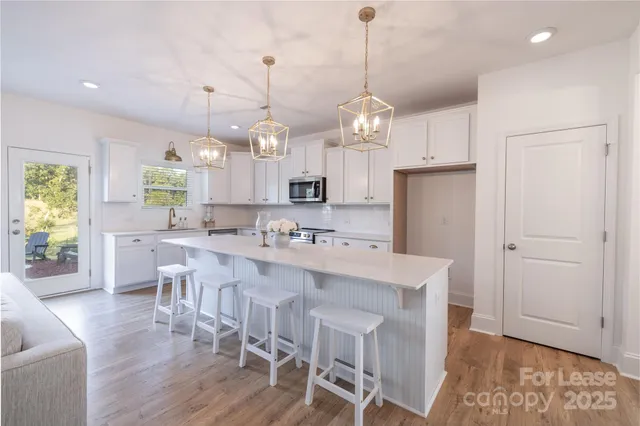 a large kitchen with lots of counter space and refrigerator