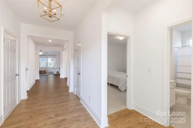 a view of a hallway with wooden floor and closet