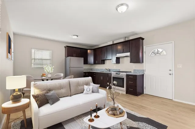 a living room with furniture and a wooden floor