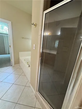 a bathroom with a glass door shower and a mirror