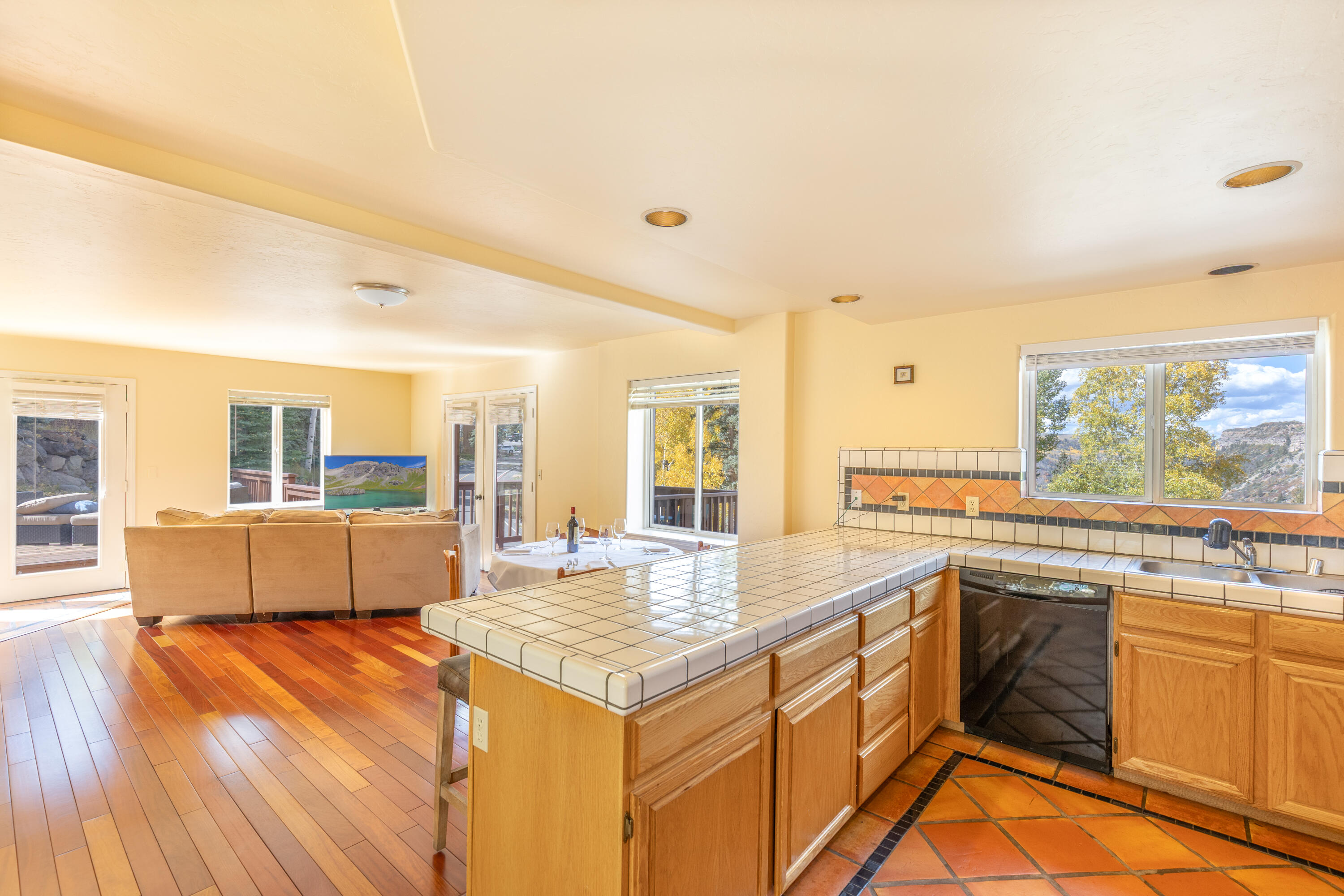 464 San Miguel Ridge, Unit 1 Telluride, CO 81435 - Photo 12 of 27 a living room with kitchen island granite countertop furniture and a kitchen view