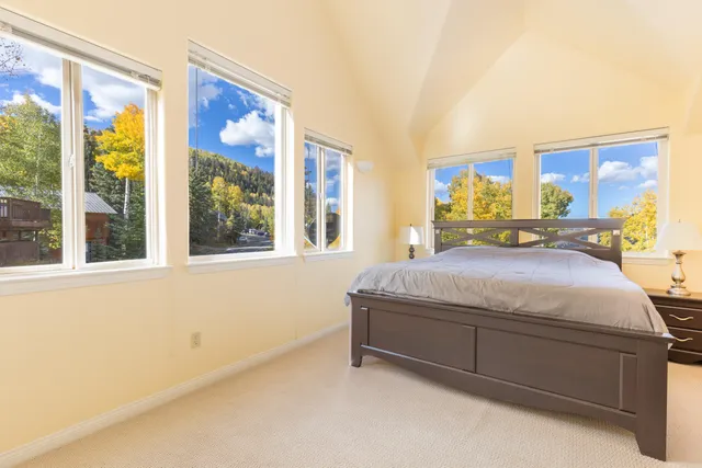 a bedroom with a large bed and a large window