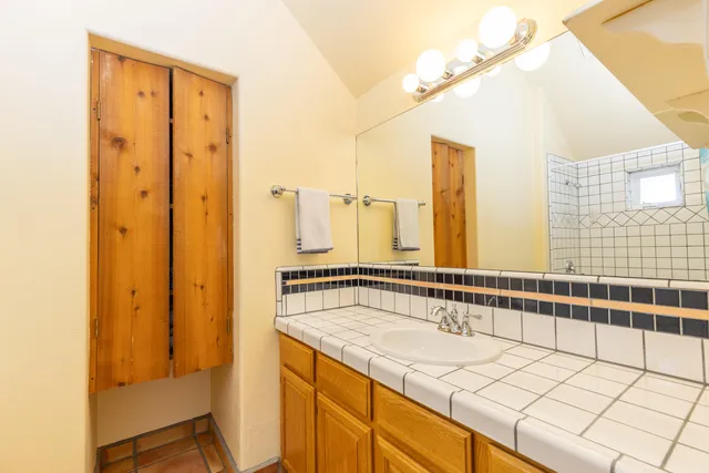 a bathroom with a shower and a sink