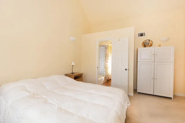 a large bed in a white room