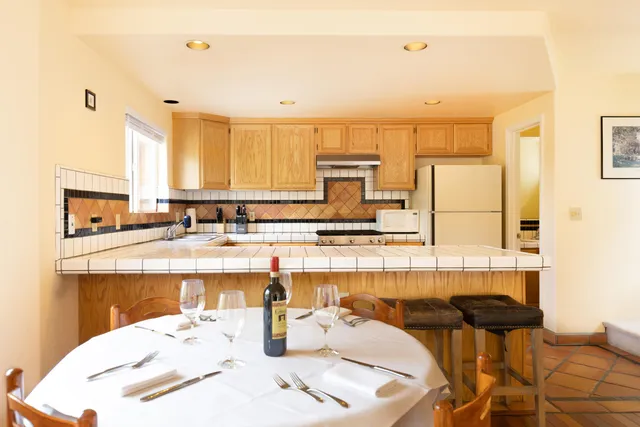 a kitchen with stainless steel appliances kitchen island granite countertop a sink and cabinets