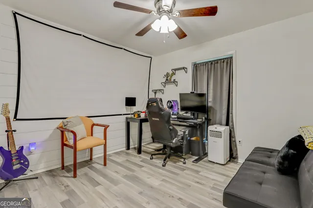 a view of a workspace with furniture and a window