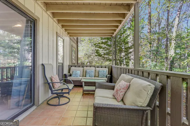 a balcony with furniture and a potted plant