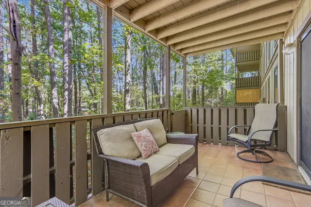 a balcony with furniture and large windows