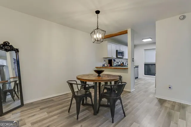 a view of a dining room with furniture wooden floor and a chandelier