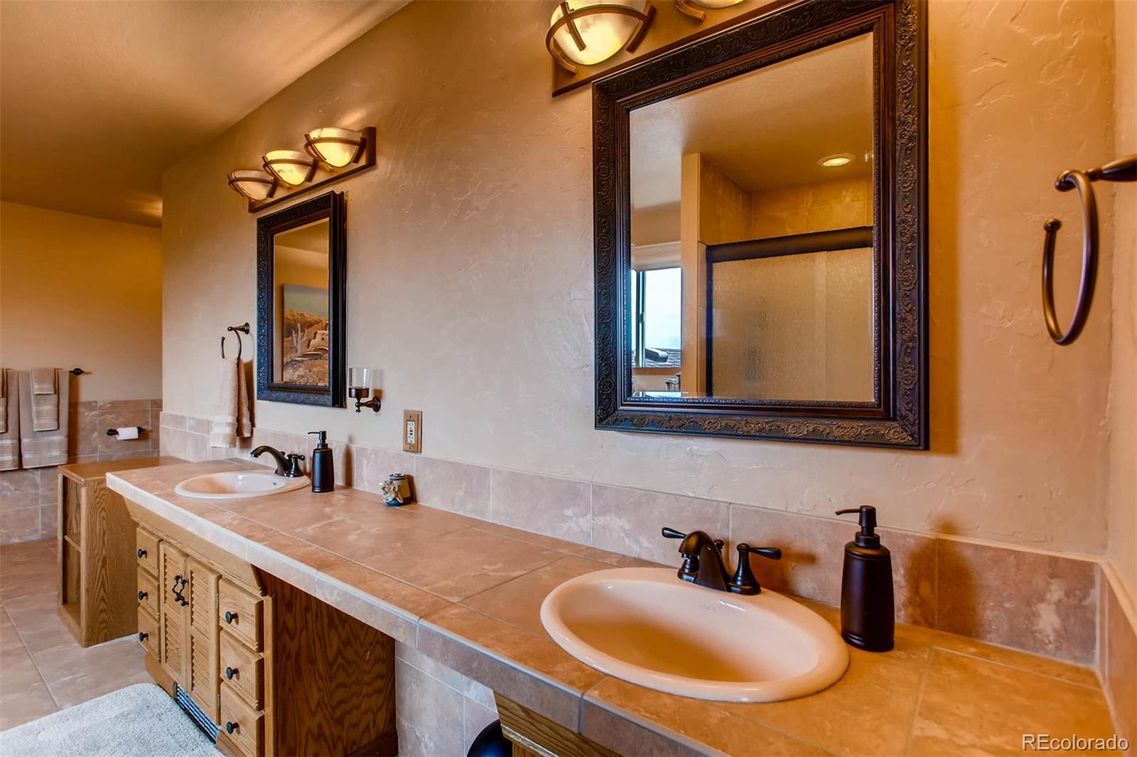 881 Valley Road Littleton, CO 80124 - Photo 23 of 27 a bathroom with a sink and a mirror
