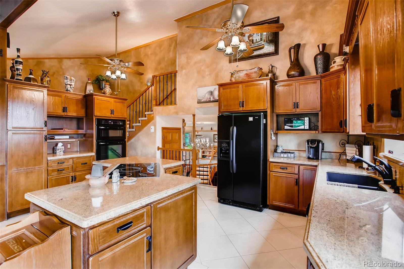 881 Valley Road Littleton, CO 80124 - Photo 3 of 27 a kitchen with stainless steel appliances granite countertop a sink a stove and refrigerator