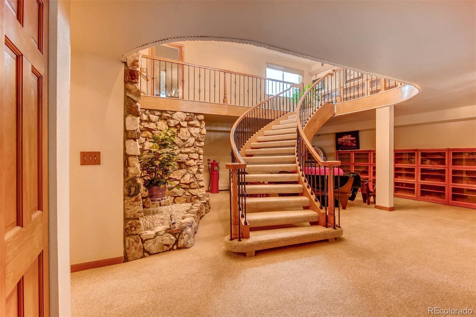 881 Valley Road Littleton, CO 80124 - Photo 5 of 27 a view of a livingroom with stairs and a couch