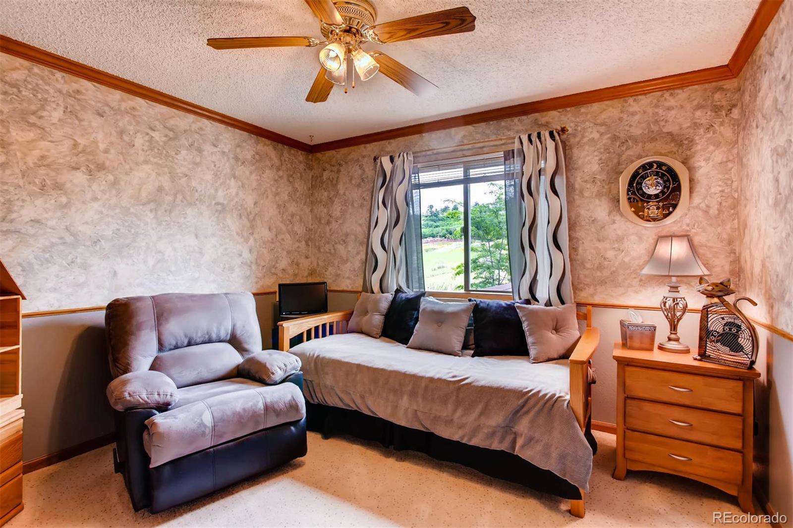881 Valley Road Littleton, CO 80124 - Photo 7 of 27 a bedroom with a bed couch and window