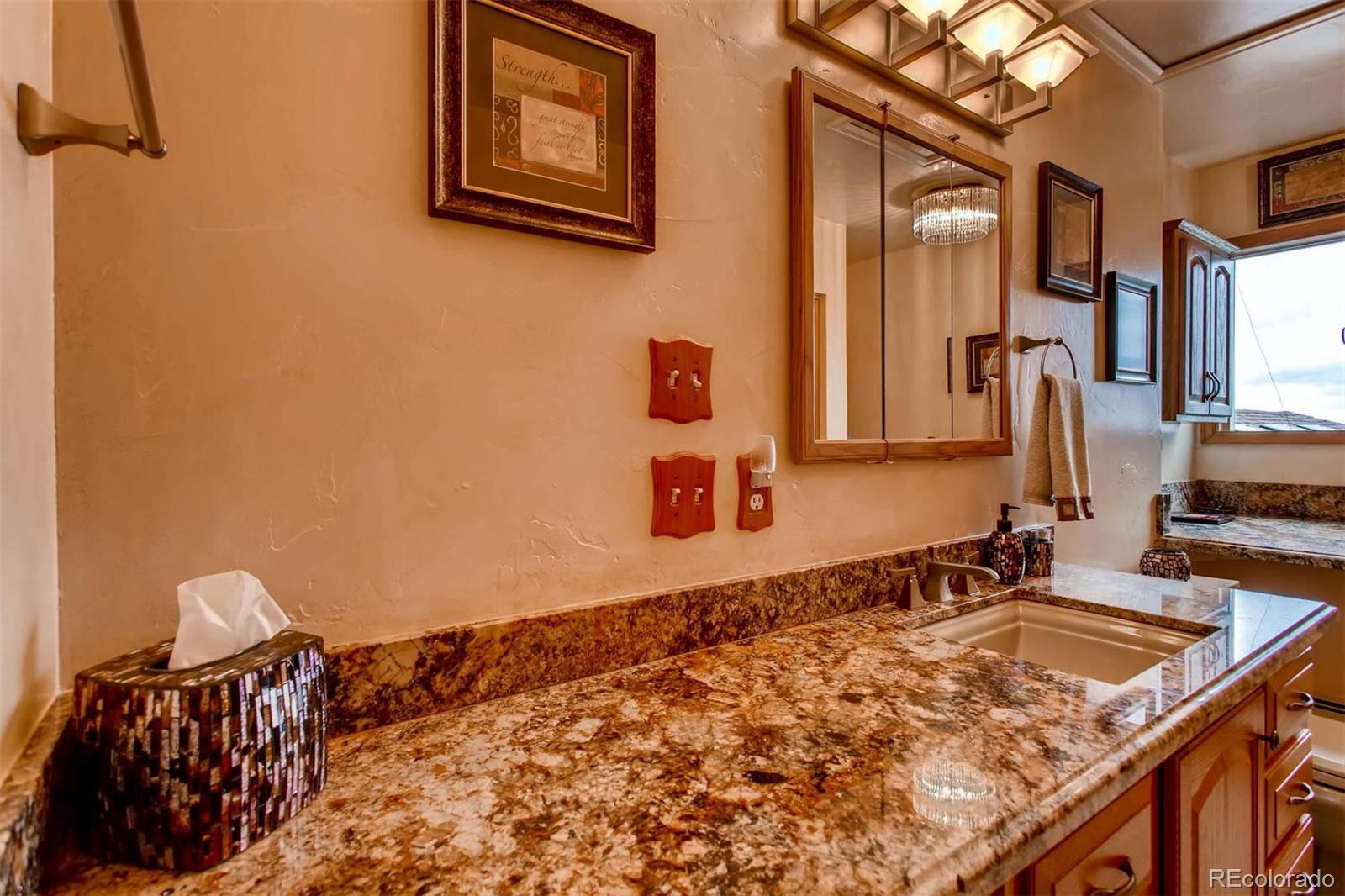 881 Valley Road Littleton, CO 80124 - Photo 9 of 27 a bathroom with a granite countertop sink and a mirror