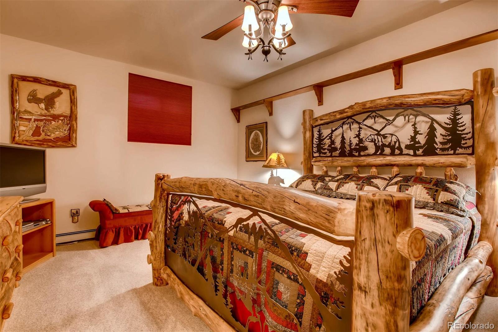881 Valley Road Littleton, CO 80124 - Photo 10 of 27 a bedroom with a bed and wooden floor