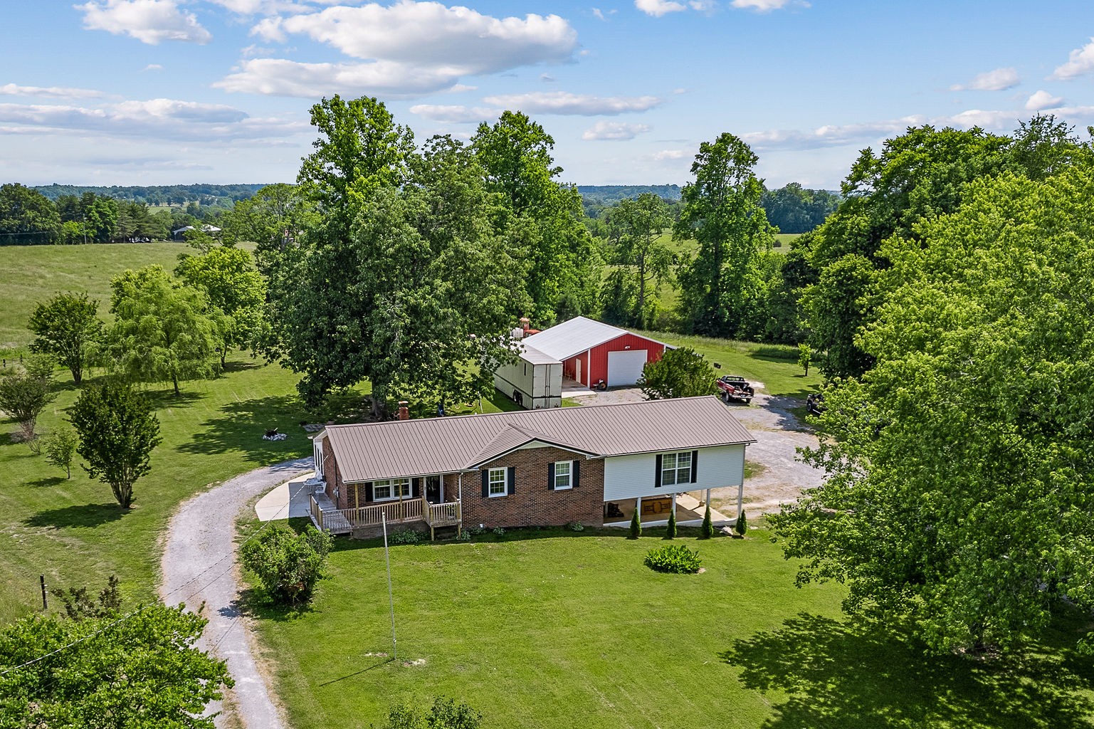 a aerial view of a house with table and chairs under an umbrella