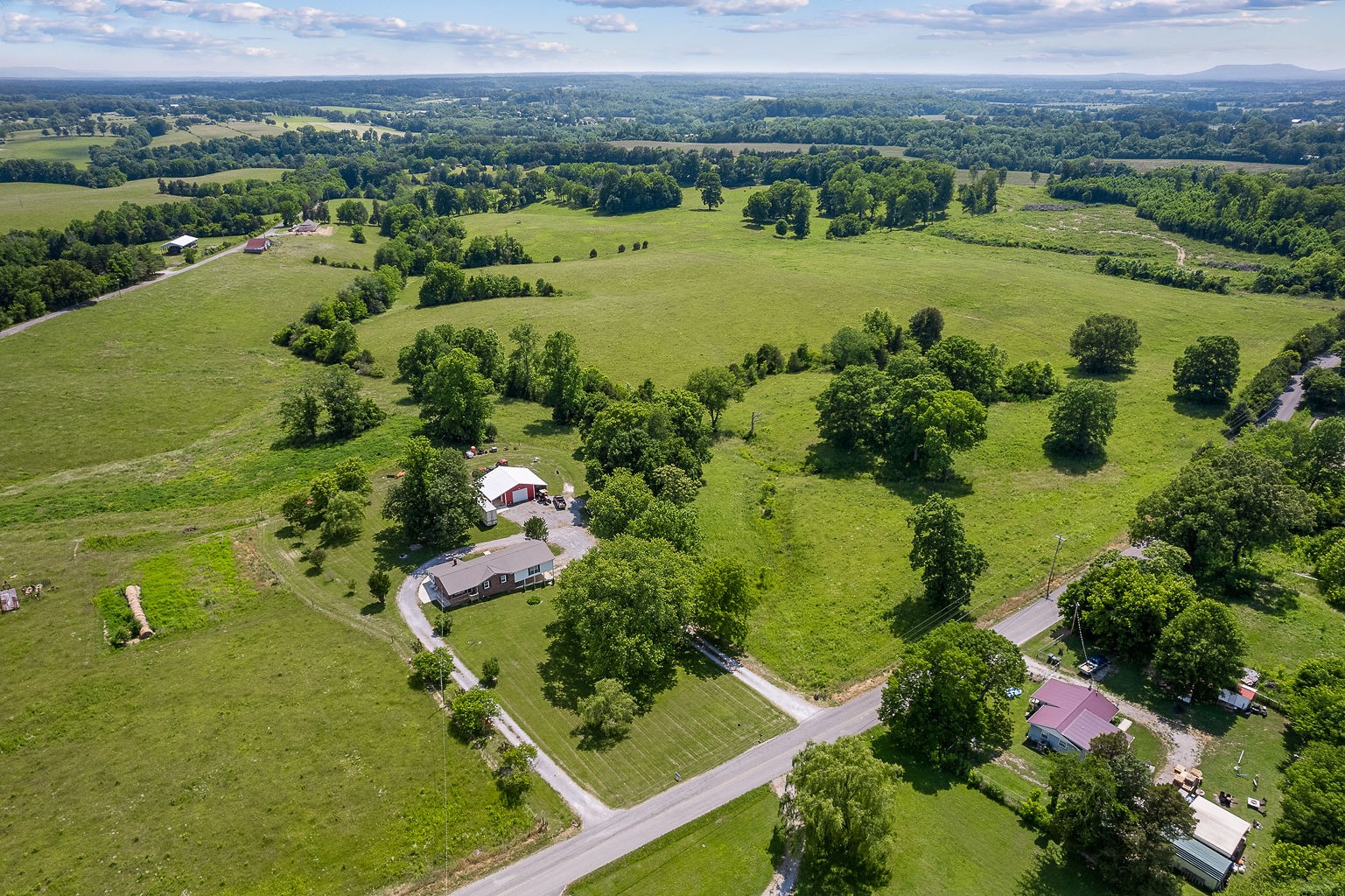 1514 Jefferson Road Smithville, TN 37166 - Photo 12 of 53 an aerial view of green landscape with trees houses and lake view