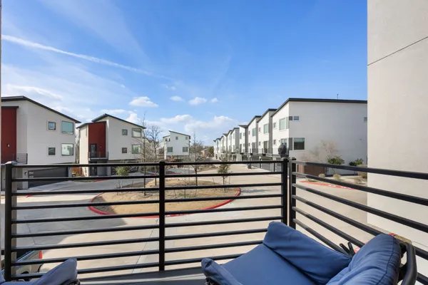 a kitchen with cabinets a sink and chairs