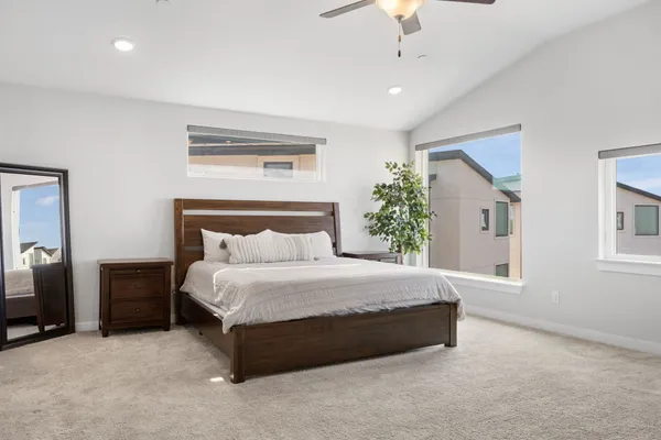 a living room with furniture and large windows