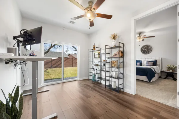 a view of a livingroom with furniture and a ceiling fan