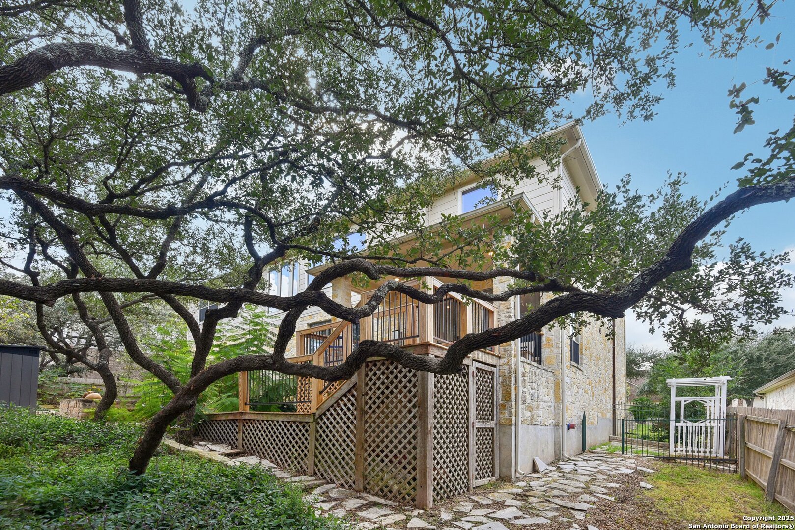 522 Heather Ridge San Antonio, TX 78260 - Photo 40 of 41 a view of a house with a tree and wooden fence