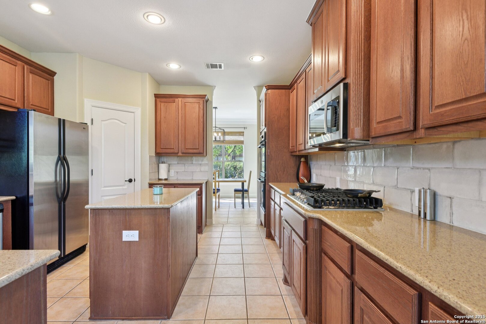 522 Heather Ridge San Antonio, TX 78260 - Photo 7 of 41 a kitchen with stainless steel appliances granite countertop a refrigerator a stove and a sink