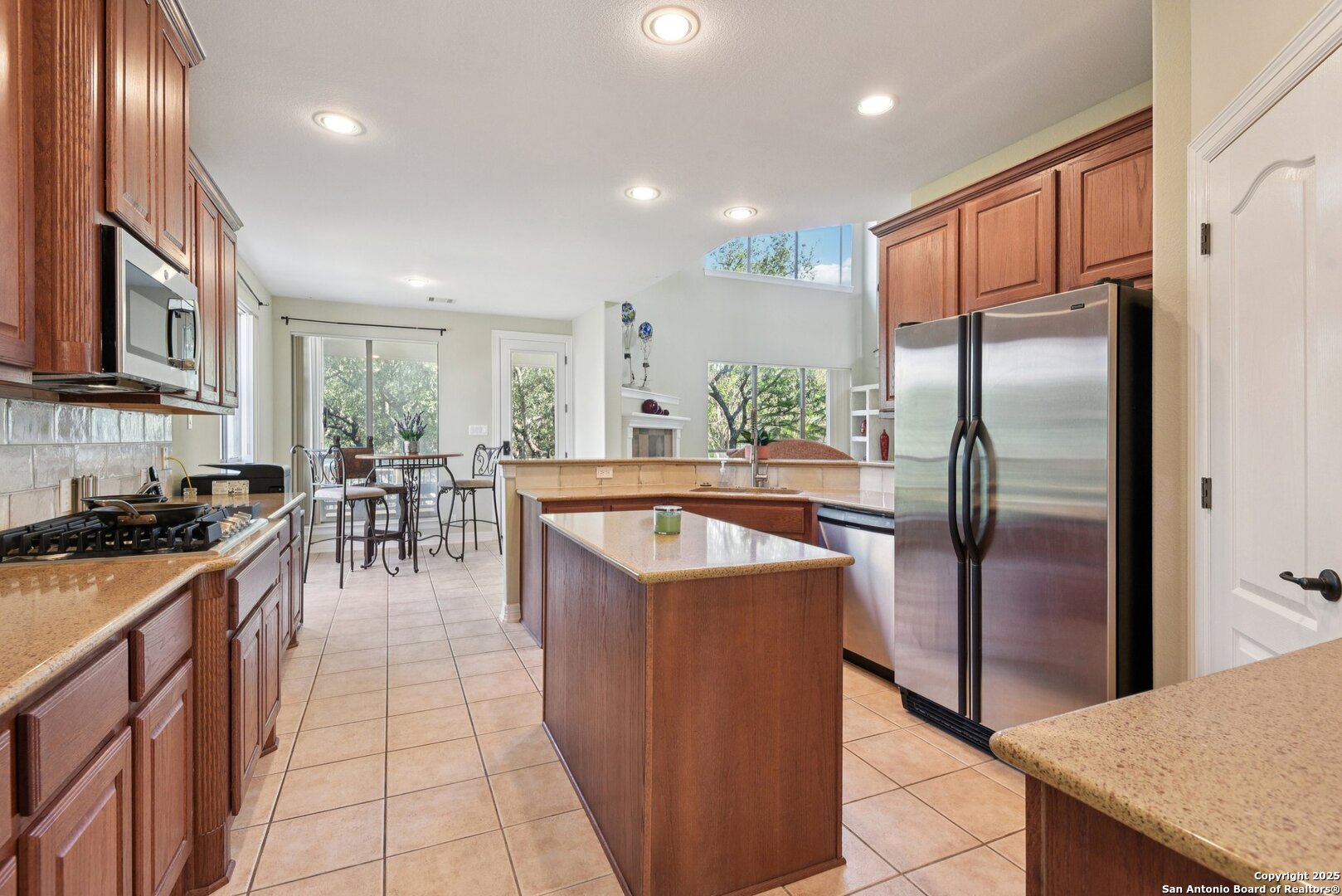 522 Heather Ridge San Antonio, TX 78260 - Photo 8 of 41 a kitchen with stainless steel appliances granite countertop a stove refrigerator and a sink