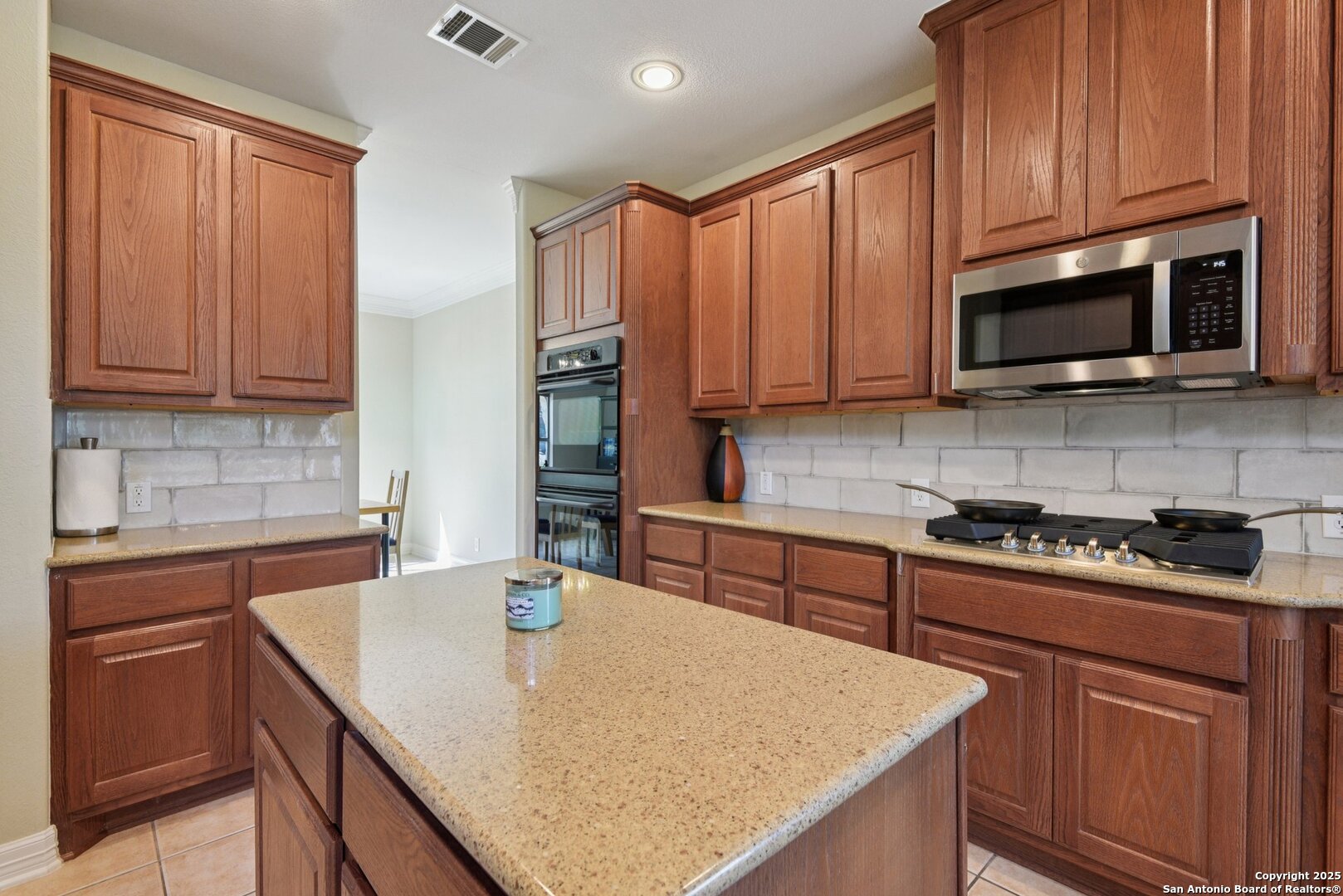 522 Heather Ridge San Antonio, TX 78260 - Photo 9 of 41 a kitchen with stainless steel appliances granite countertop wooden cabinets a stove top oven a sink and dishwasher
