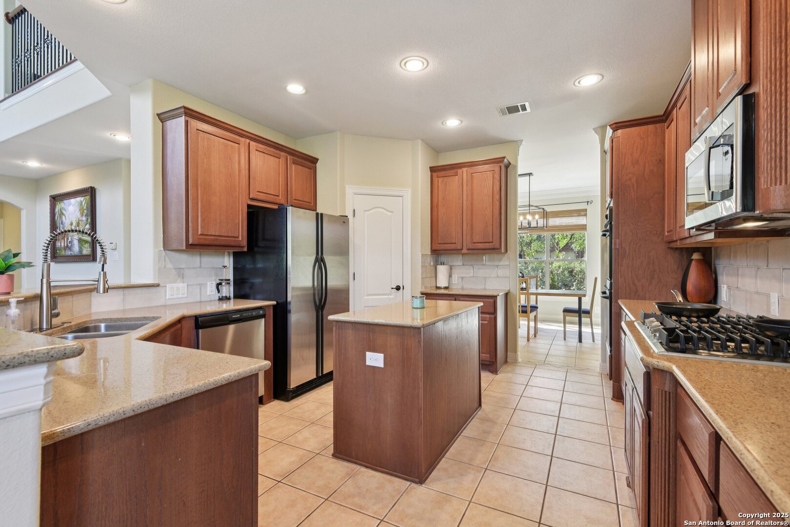 522 Heather Ridge San Antonio, TX 78260 - Photo 10 of 41 a kitchen with stainless steel appliances granite countertop a sink stove and refrigerator