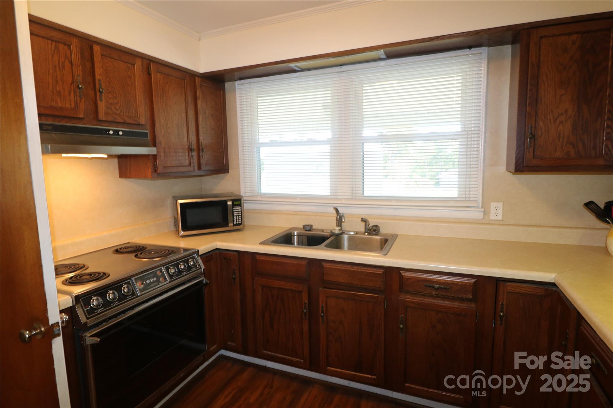 1260 Highway 221 Rutherfordton, NC 28139 - Photo 16 of 30 a kitchen with stainless steel appliances a stove a sink and a window