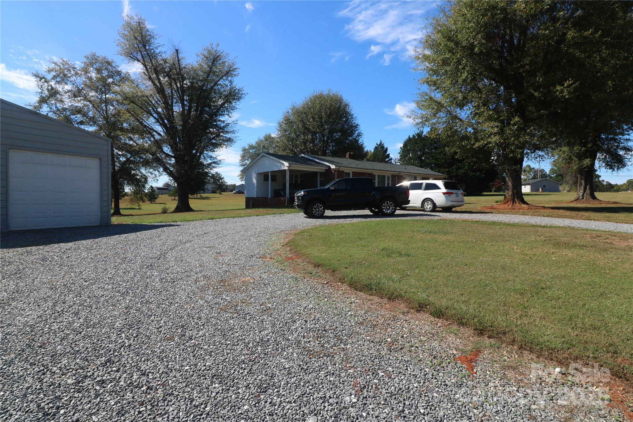 1260 Highway 221 Rutherfordton, NC 28139 - Photo 9 of 30 a view of a house with a yard and large trees