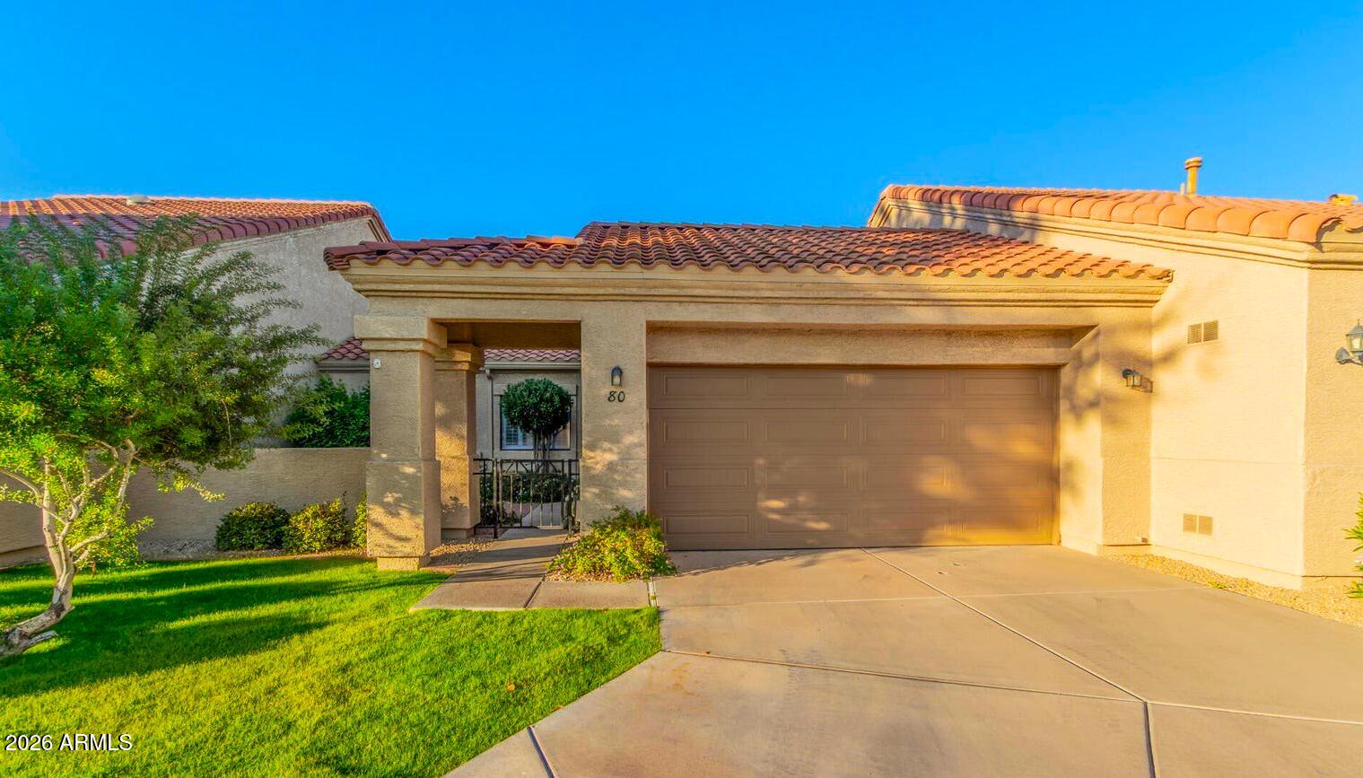 45 East 9th Place, Unit 80 Mesa, AZ 85201 - Photo 1 of 38 a front view of a house with a garden