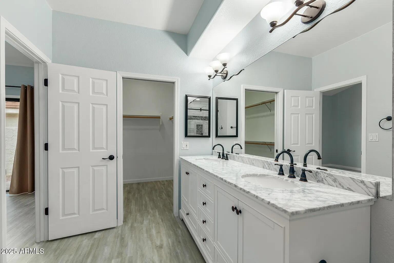 45 East 9th Place, Unit 80 Mesa, AZ 85201 - Photo 14 of 38 a bathroom with double vanity sinks a vanity a lamp and a mirror