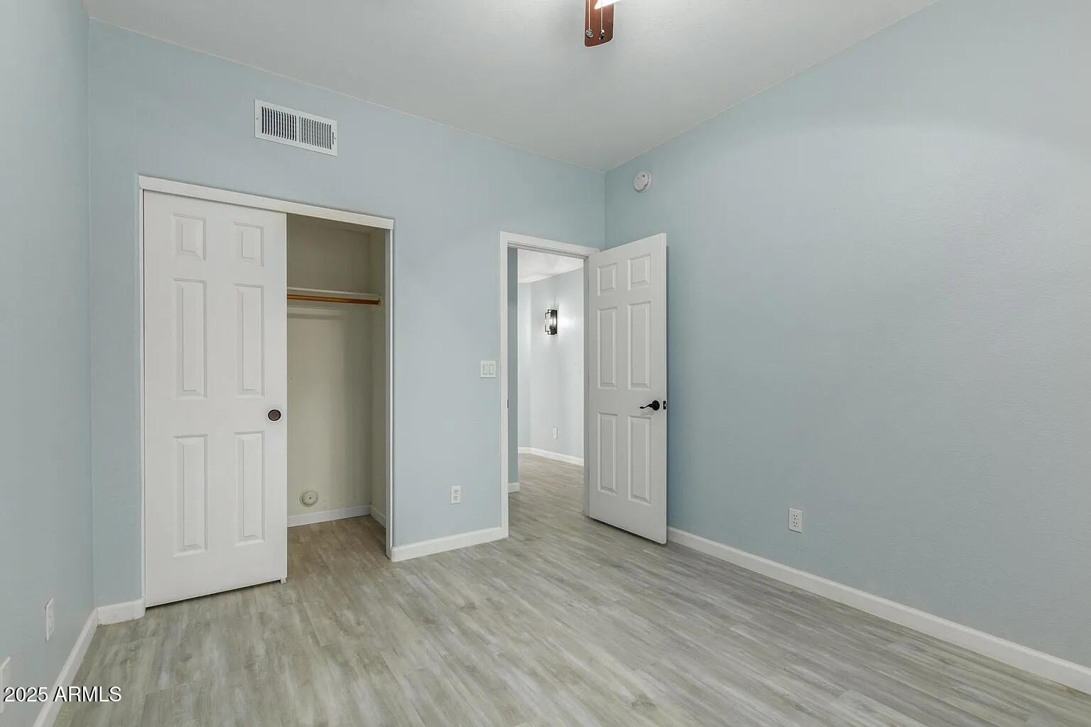 45 East 9th Place, Unit 80 Mesa, AZ 85201 - Photo 15 of 38 a view of an empty room with wooden floor