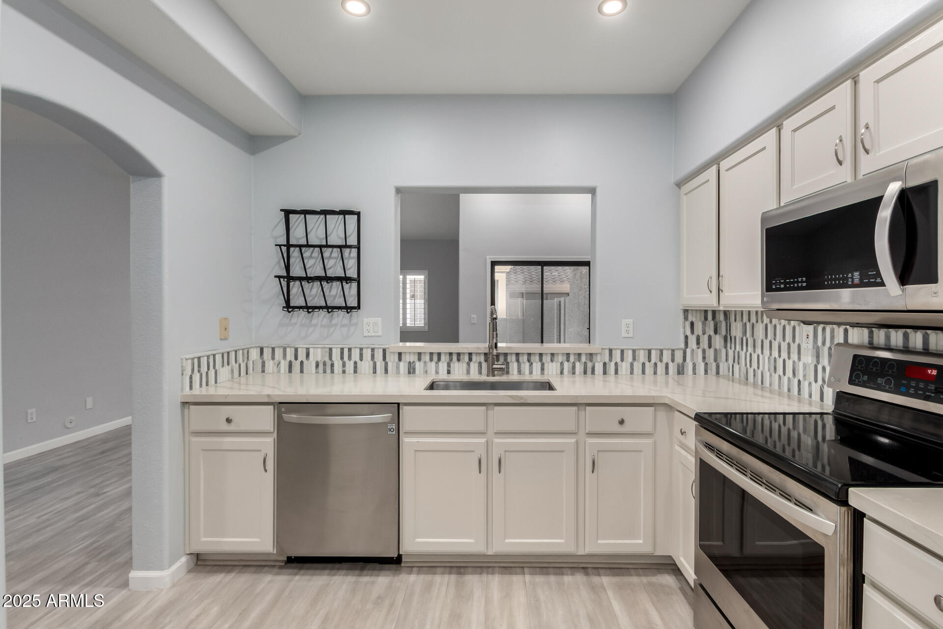 45 East 9th Place, Unit 80 Mesa, AZ 85201 - Photo 4 of 38 a kitchen with white cabinets and appliances