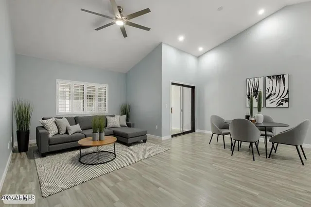 a living room with furniture and a wooden floor