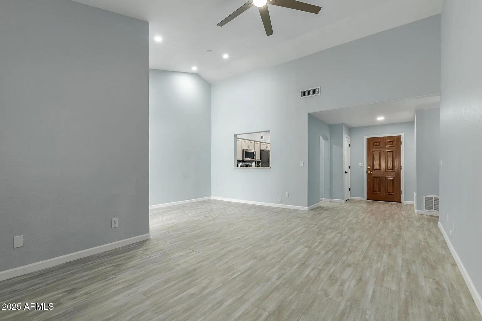 45 East 9th Place, Unit 80 Mesa, AZ 85201 - Photo 7 of 38 an empty room with wooden floor and ceiling fan