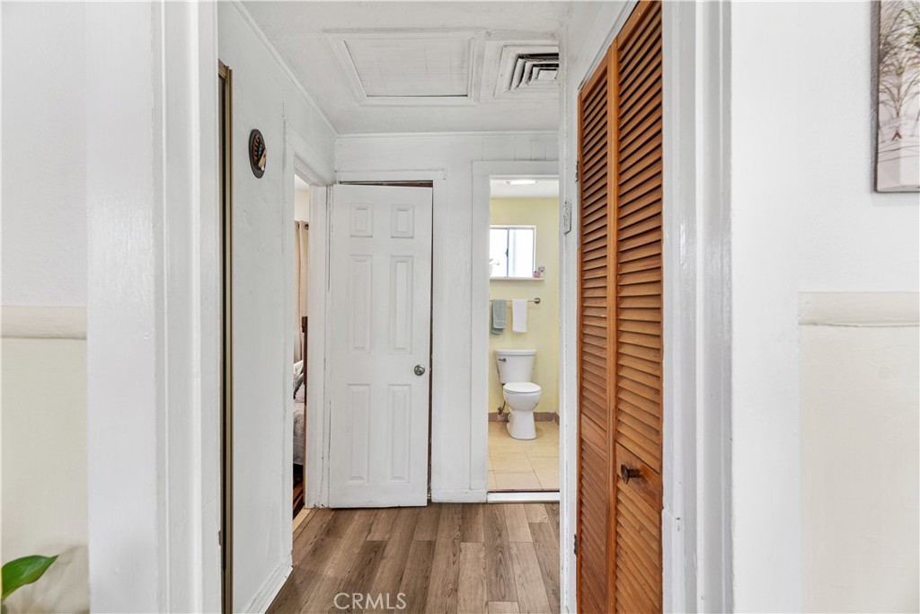 2113 Princeton Street Delano, CA 93215 - Photo 12 of 32 a view of a bathroom with a door and wooden floor