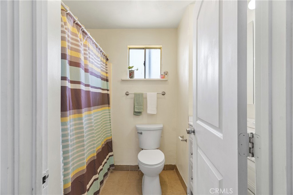 2113 Princeton Street Delano, CA 93215 - Photo 14 of 32 a bathroom with a toilet and a shower