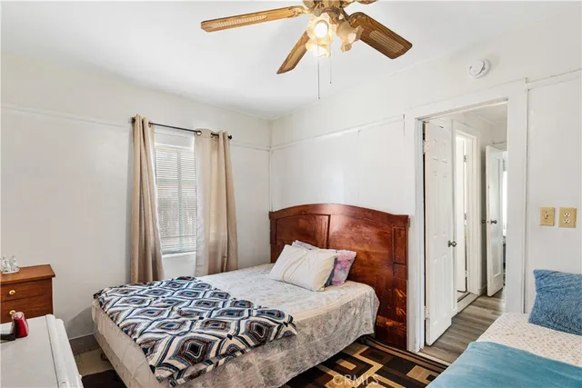 a bedroom with a bed and flat screen tv